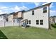 Spacious backyard with artificial turf and patio seating area at 625 Sage Oak Ln, Holly Springs, NC 27540