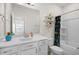Stylish bathroom featuring a vanity with sink, decorative shower curtain, and a modern, decorative wall-shelf at 625 Sage Oak Ln, Holly Springs, NC 27540