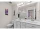 Well-lit bathroom with a dual-sink vanity, framed mirrors, and modern fixtures at 625 Sage Oak Ln, Holly Springs, NC 27540