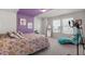 Cozy bedroom with a comfortable bed, chaise lounge, and ample natural light from the windows at 625 Sage Oak Ln, Holly Springs, NC 27540