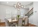Dining room with contemporary light fixture and open floor plan at 625 Sage Oak Ln, Holly Springs, NC 27540