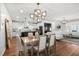 Open-concept space with a dining area and contemporary lighting at 625 Sage Oak Ln, Holly Springs, NC 27540