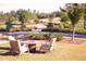 Community firepit area with outdoor seating and a view of the lush golf course beyond at 625 Sage Oak Ln, Holly Springs, NC 27540