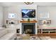 Living room fireplace with TV, built-in shelving, and modern decor at 625 Sage Oak Ln, Holly Springs, NC 27540