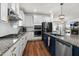 Granite countertops with stainless steel appliances and hardware in this well-appointed kitchen at 625 Sage Oak Ln, Holly Springs, NC 27540