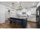 Open kitchen with large island, pendant lighting, and modern appliances creating a warm and inviting space at 625 Sage Oak Ln, Holly Springs, NC 27540