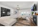 Open concept living room with a fireplace, and large white sectional sofa at 625 Sage Oak Ln, Holly Springs, NC 27540