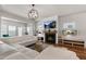 Spacious living room with a fireplace, modern light fixture, and large white sectional at 625 Sage Oak Ln, Holly Springs, NC 27540