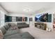 Comfortable living room with large sectional sofa, movie themed wall decor, and entertainment center at 625 Sage Oak Ln, Holly Springs, NC 27540