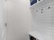 Bright mudroom with a built-in bench, shelving, and hooks for organization at 625 Sage Oak Ln, Holly Springs, NC 27540