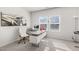 Bright office featuring a modern desk, ergonomic chair, and natural light from dual windows at 625 Sage Oak Ln, Holly Springs, NC 27540
