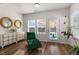 Bright sunroom with lots of natural light, a decorative dresser, and comfortable seating at 625 Sage Oak Ln, Holly Springs, NC 27540