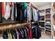 Well-organized walk-in closet with shelving and hanging storage for clothes, shoes, and accessories at 625 Sage Oak Ln, Holly Springs, NC 27540