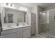 Modern bathroom with double vanity, sleek mirrors, and glass-enclosed shower for a luxurious feel at 63 Pale Moss Dr, Clayton, NC 27527