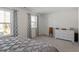 Well-lit bedroom with a cozy bed, neutral carpet, and two large windows for ample natural light at 63 Pale Moss Dr, Clayton, NC 27527