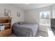 Cozy bedroom with neutral carpet, a bookshelf, and a sunny window, creating a welcoming space at 63 Pale Moss Dr, Clayton, NC 27527