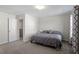 Cozy bedroom with neutral walls, plush carpeting, and a comfortable queen-sized bed at 63 Pale Moss Dr, Clayton, NC 27527