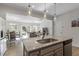 Open-concept kitchen with an island, stainless appliances, and a view of the dining and living areas at 63 Pale Moss Dr, Clayton, NC 27527