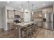 Modern kitchen featuring stainless steel appliances, a center island with seating, and stylish pendant lighting at 63 Pale Moss Dr, Clayton, NC 27527