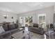 Bright living room featuring comfortable seating, natural light, and seamless access to the dining area at 63 Pale Moss Dr, Clayton, NC 27527