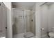 Contemporary shower featuring tile surround, built-in niche, and a sleek glass door at 63 Pale Moss Dr, Clayton, NC 27527