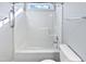 Bright bathroom featuring a shower-tub combo with grab bar and a window for natural light at 6624 Professor St, Raleigh, NC 27616