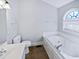 Bright bathroom featuring soaking tub and vanity sink at 6624 Professor St, Raleigh, NC 27616