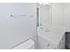 Bathroom featuring a white vanity, a sink, chrome fixtures, and a large mirror at 6624 Professor St, Raleigh, NC 27616