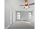 Large bedroom with carpet, ceiling fan, and natural light at 6624 Professor St, Raleigh, NC 27616