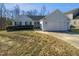 Charming single-story home featuring a manicured lawn, arched windows, and a two-car garage at 6624 Professor St, Raleigh, NC 27616
