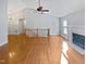 Open living area featuring hardwood floors, fireplace and stairs at 6624 Professor St, Raleigh, NC 27616