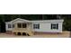 Charming single-story home with a inviting front porch and neutral siding at 6646 Woodlawn Dr, Oxford, NC 27565