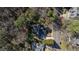 Bird's-eye view of the home surrounded by mature trees, offering privacy and a sense of seclusion at 6816 Rainwater Rd, Raleigh, NC 27615
