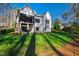 Well-manicured backyard with a covered patio, lush lawn, and privacy fencing at 6816 Rainwater Rd, Raleigh, NC 27615