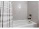 Clean white bathtub with a neutral shower curtain and subway-tiled walls, perfect for relaxation at 6816 Rainwater Rd, Raleigh, NC 27615