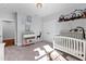 Charming Bedroom with a crib, changing table, and delightful decorations creating a warm atmosphere at 6816 Rainwater Rd, Raleigh, NC 27615