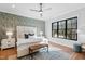 Stylish bedroom features a ceiling fan, hardwood floors and accent wall at 6816 Rainwater Rd, Raleigh, NC 27615