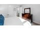 Bedroom with wooden dresser, mirror and view to an adjoining room at 6816 Rainwater Rd, Raleigh, NC 27615