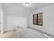 Bright bedroom features neutral carpet, a modern window, and a cozy bed frame at 6816 Rainwater Rd, Raleigh, NC 27615
