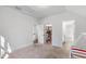 A neutral bedroom provides entry to a large closet and has neutral carpet, perfect for relaxation at 6816 Rainwater Rd, Raleigh, NC 27615