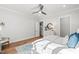 Bright bedroom featuring a ceiling fan, wood floors, and white furniture at 6816 Rainwater Rd, Raleigh, NC 27615