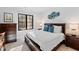 Bedroom with wooden bed frame, decorative pillows, and view to the outdoors at 6816 Rainwater Rd, Raleigh, NC 27615