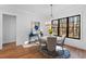 Bright and airy dining room with hardwood floors, large windows, and stylish chandelier at 6816 Rainwater Rd, Raleigh, NC 27615