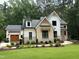 Charming two-story home featuring a brick and siding exterior with a lush green lawn at 6816 Rainwater Rd, Raleigh, NC 27615