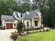 Beautiful home featuring manicured landscaping, a side-entry garage, and a well-maintained lawn at 6816 Rainwater Rd, Raleigh, NC 27615
