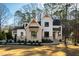 Elegant two-story home featuring a modern design with a combination of white siding and brick accents at 6816 Rainwater Rd, Raleigh, NC 27615