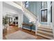 Spacious foyer featuring a staircase, hardwood floors, and an open view into the living room at 6816 Rainwater Rd, Raleigh, NC 27615