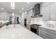 A bright kitchen with stainless steel appliances, gas range, and a large kitchen island at 6816 Rainwater Rd, Raleigh, NC 27615