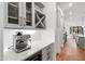 Coffee bar area features gray cabinetry, a wine cooler and quartz countertop at 6816 Rainwater Rd, Raleigh, NC 27615