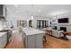 Bright kitchen features an island with bar stool seating, stainless steel appliances, and an open floor plan at 6816 Rainwater Rd, Raleigh, NC 27615